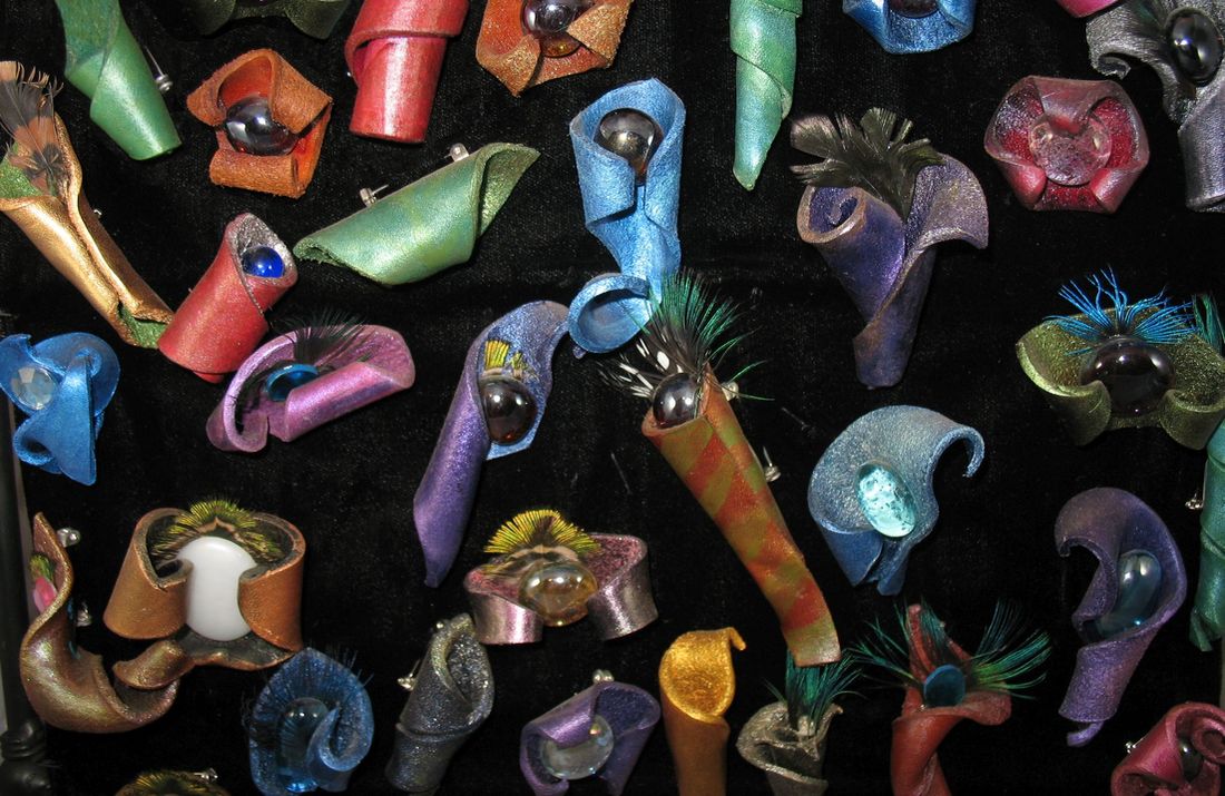 Unique molded leather pins in various colors.
